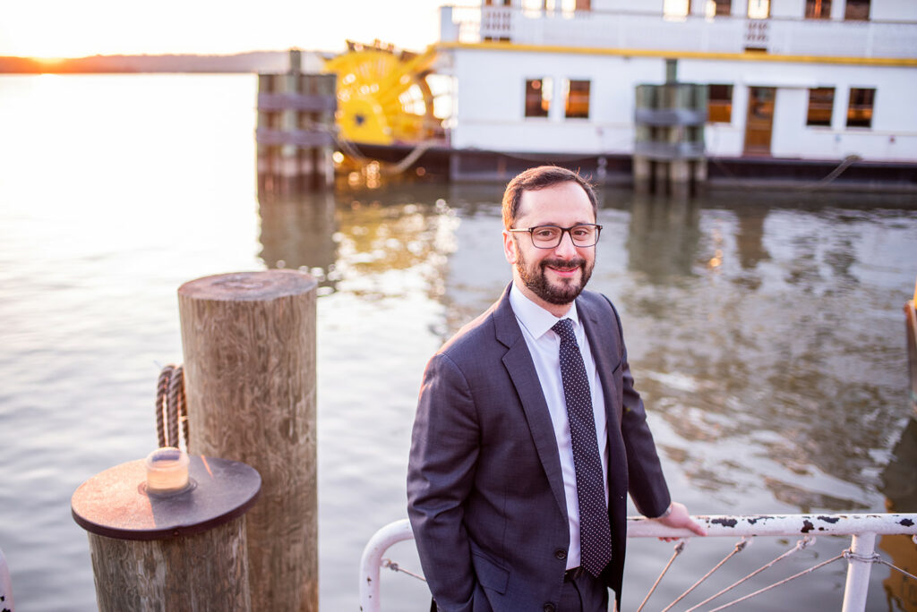 attorney payman on a pier posing with hand on a chain