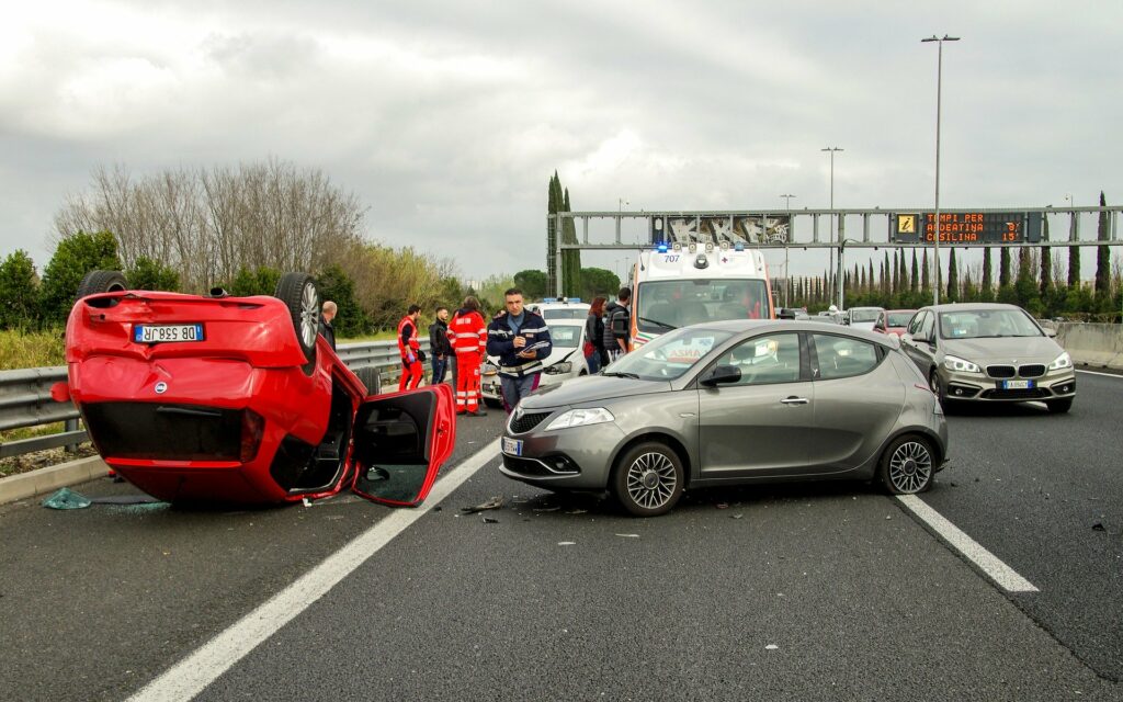Auto accident, car flipped over on highway