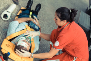 EMT with person with head injury