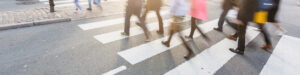 people walking across a crosswalk